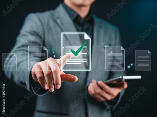 A businessman in a suit interacts with a digital document interface on his phone