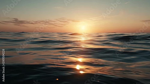 Breathtaking tranquil ocean sunset with golden light reflecting on the calm rippling water surface, creating a serene and picturesque natural scene