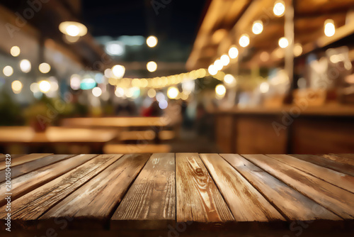 Outdooor dining at night, warm string lights over tables, wooden deck