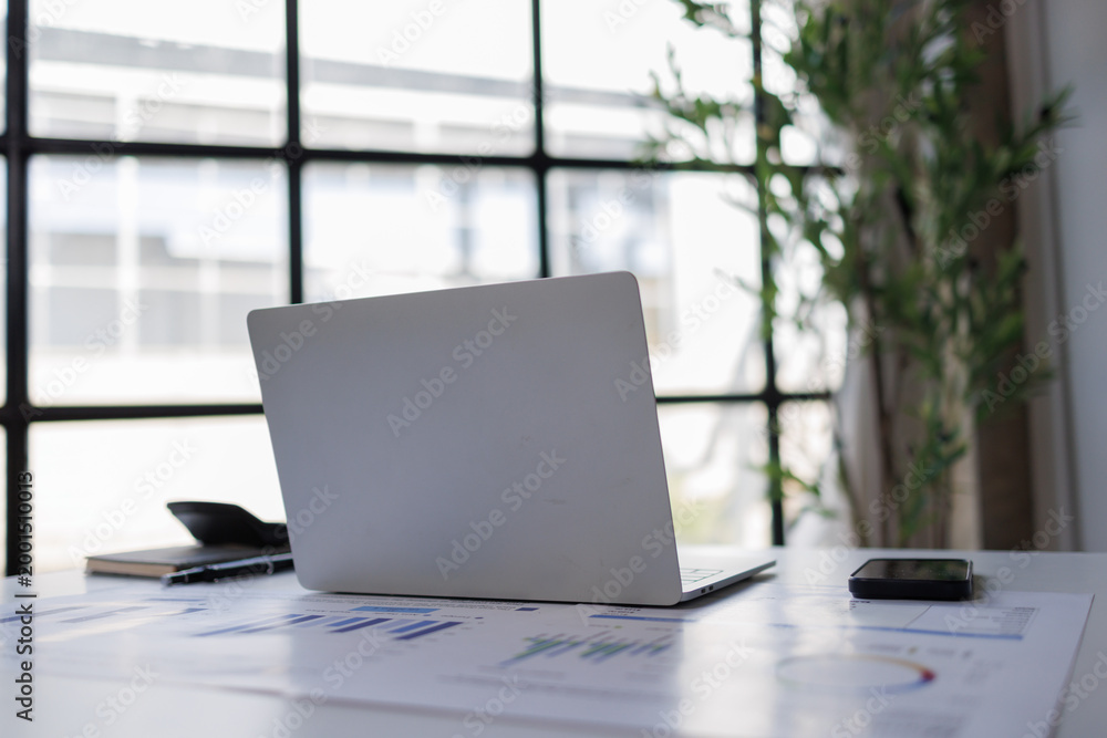 Fototapeta premium Workstation with laptop, documents, and smartphone on a desk