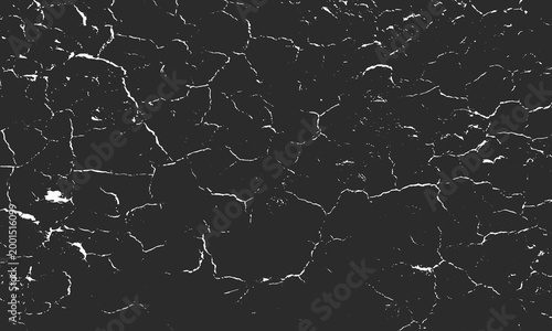 Close-up of cracked dark surface with irregular white lines forming abstract fractured texture, resembling dried earth or aged paint