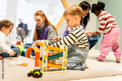 Foto Children playing with toys at an indoor daycare center