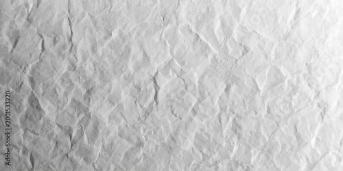 A blank white paper and wrinkled fabric texture with a crumpled surface design creates a seamless gray grunge backdrop on an old rough stone wall sheet