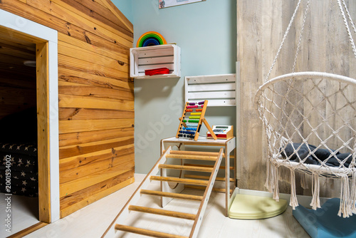 Foto Colorful playroom with abacus and macrame swing chair