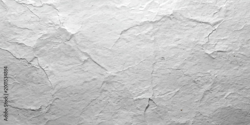 White marble and paper texture on a white painted wall featuring a wrinkled, blank sheet with a rough grunge pattern on an aged vintage surface