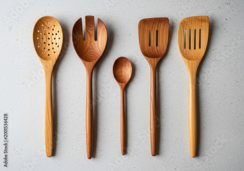 Collection of wooden kitchen utensils on a light background