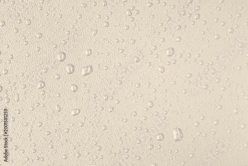 Macro leather texture with water drops, waterproof and hydrophobic surface concept, classical warm beige background