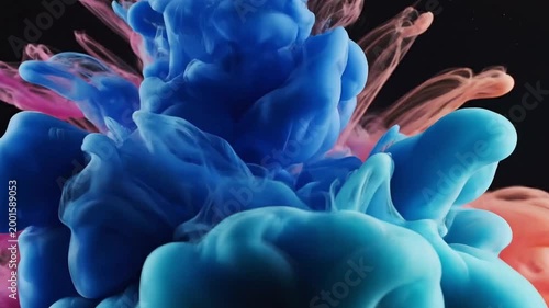 Colorful ink splash swirling in water creating abstract shapes  