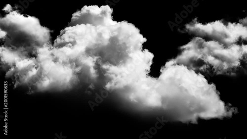 A wispy, fluffy cloud formation floats against a stark black background, creating a dramatic contrast