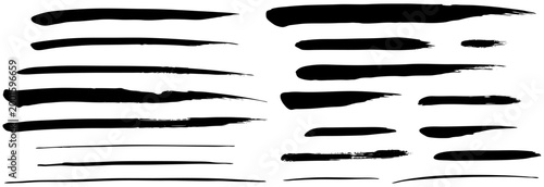 Manual long ink strokes set. Created with large synthetic brush for smooth and elastic paint marks. Hand-painted black stripes and fluid artistic lines on white background.