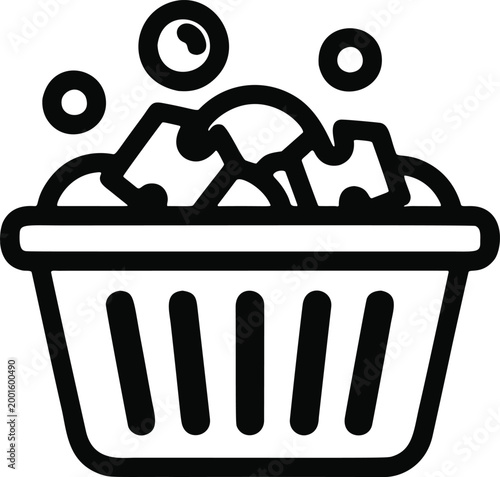 Soapy Laundry Basket With Bubbles. Laundry basket filled with clothes and soap bubbles representing cleaning and household washing.