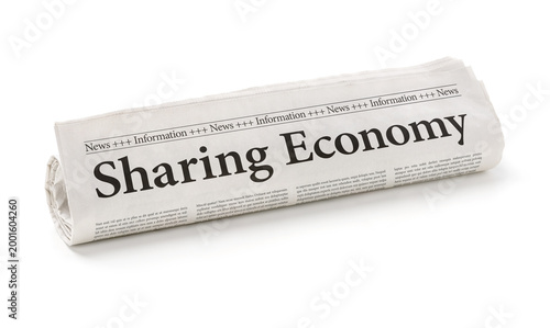 Rolled newspaper with the headline Sharing Economy