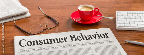 A newspaper on a wooden desk - Consumer Behavior
