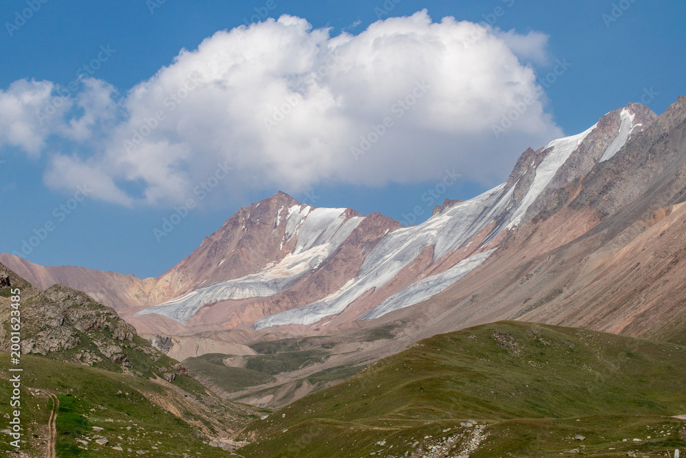 Fototapeta premium A view of massive glacial formations on the slopes near Mount Satpayev in the Tien Shan Mountains.