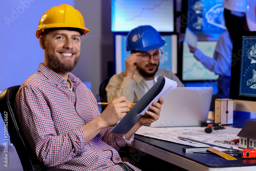 Male engineer with clipboar...