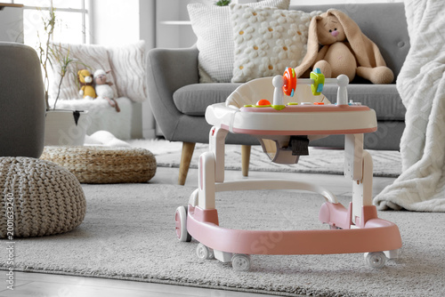 Baby walker on carpet in li...