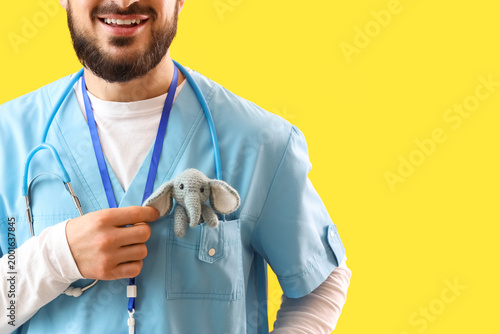 Male pediatrician with toy ...