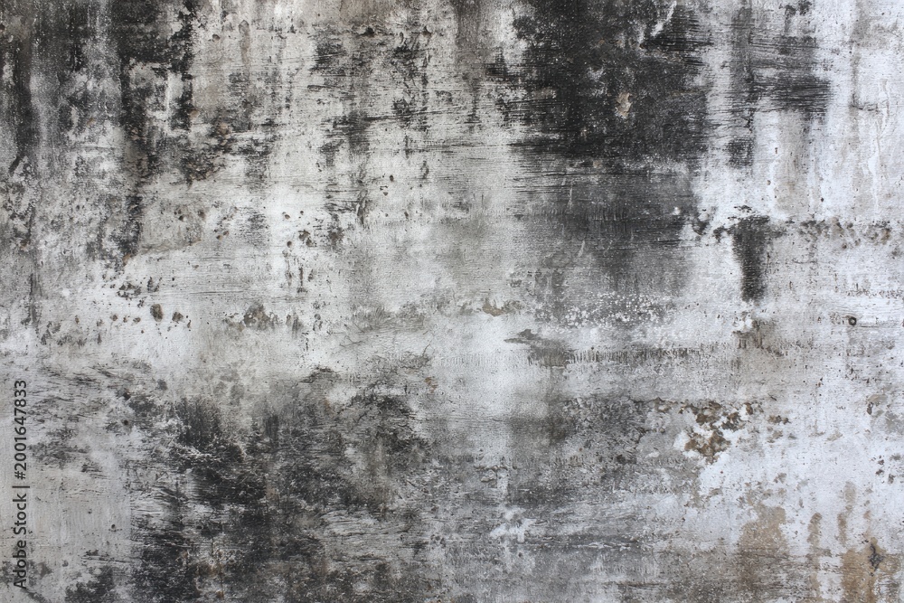 Fototapeta premium Grungy Textured Concrete Wall with Dark Stains and Patches.