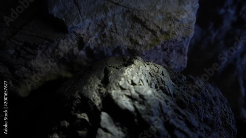 Cool light on rough rock surface with cinematic depth and texture