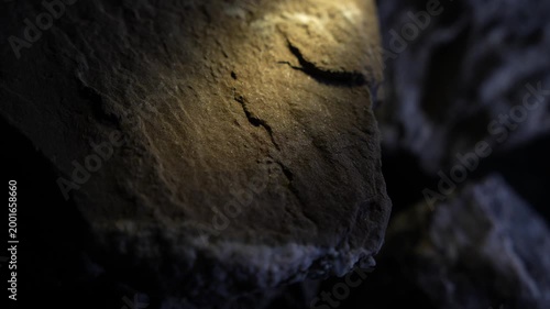 Soft warm light over smooth rock surface with subtle cinematic texture