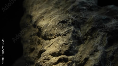 Moving light across detailed rock texture creating cinematic surface