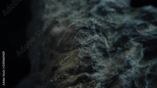 Soft light sliding over rock texture with subtle warm cinematic tones