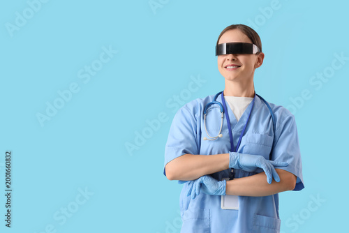 Female doctor in goggles on blue background
