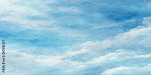 sky filled with puffy clouds, inviting tranquility and boundless freedom. The vibrant blue sky and soft, fluffy clouds create a sense of peace and serenity.
