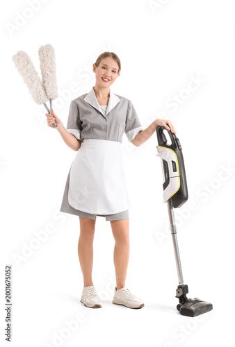 Pretty chambermaid with vac...
