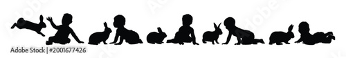 Group of happy babies and toddlers playing with rabbits black silhouette set collection vector illustration.
