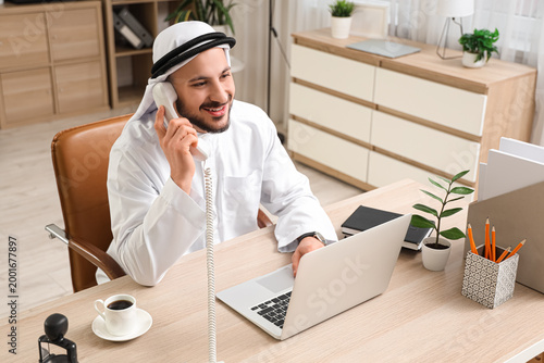 Arab businessman talking by...