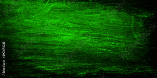 Abstract green texture with rough and grungy paint brushstrokes, creating a unique and artistic background.
