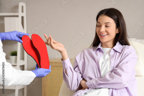 Female orthopedist giving i...