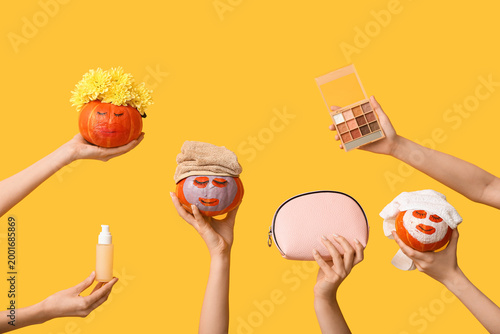 Women holding funny pumpkin...