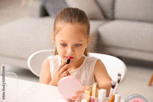 Cute little girl applying l...