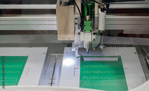 Printed circuit board drilling machine; electronic circuit board manufacturing in industrial factories.