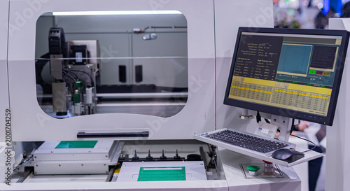 Printed circuit board drilling machine; electronic circuit board manufacturing in industrial factories.