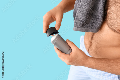 Young man with deodorant an...