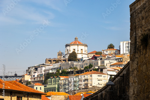 Bild auf Leinwand View of Serra do Pilar monastery above Porto rooftops from narrow street perspec