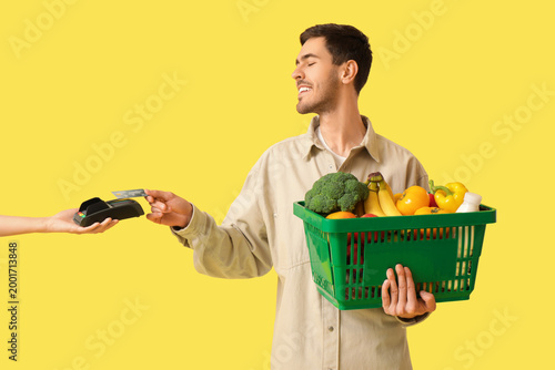 Young man with full shoppin...