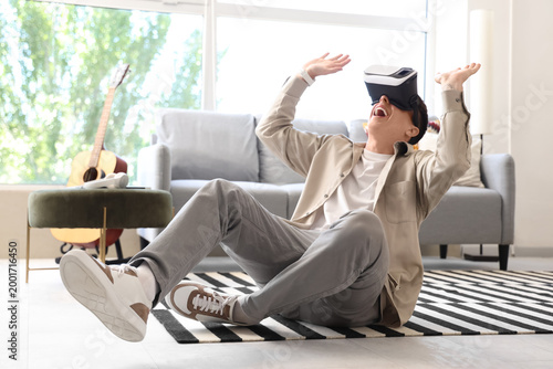 Young man using VR glasses ...