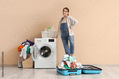 Young woman with pile of di...