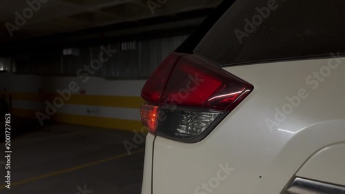 flashing red turn signal and hazard warning light on rear foot of headlight in black car. modern car, emergency stop