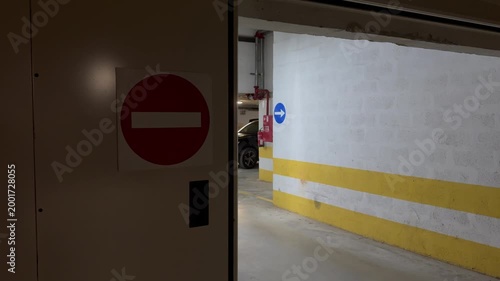 Sign of white brick in red circle passage is prohibited on background underground parking