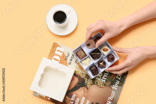Woman taking chocolate cand...