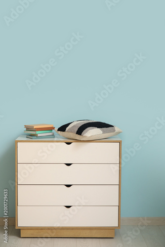 Chest of drawers with books...