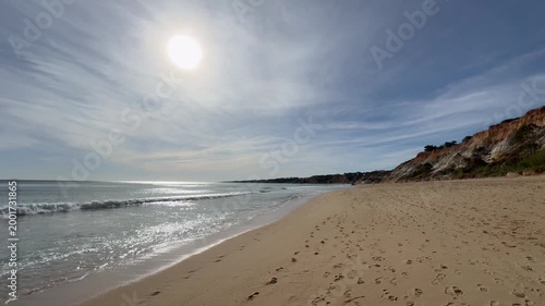 Bare footprints in the sand on a beach
