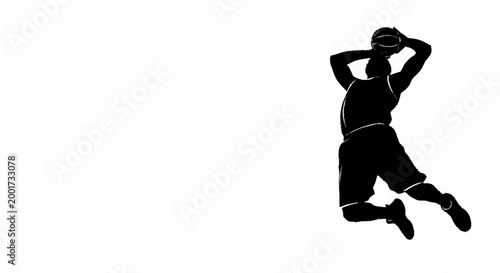 Silhouette of a basketball player jumping to shoot the ball