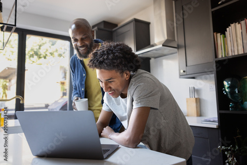 Father and son enjoying time together on laptop
