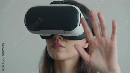 Woman is using virtual reality headset. Image with glitch effect.